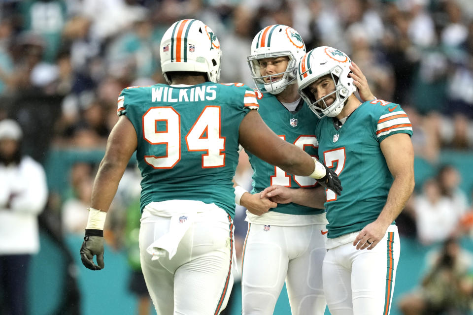 Miami Dolphins place kicker Jason Sanders (7) is congratulated by defensive tackle defensive tackle Christian Wilkins (94) (94) and punter Jake Bailey, center, after kicking a field goal during the first half of an NFL football game against the Dallas Cowboys, Sunday, Dec. 24, 2023, in Miami Gardens, Fla. (AP Photo/Rebecca Blackwell)
