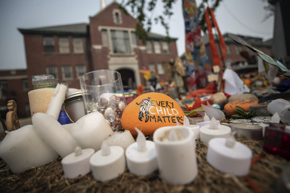 A rock with the message 'Every Child Matters' painted on it sits at a memorial outside the former Kamloops Indian Residential School, where the remains of 215 Indigenous children were discovered.  (Photo/Darryl Dyck, The Canadian Press via AP)