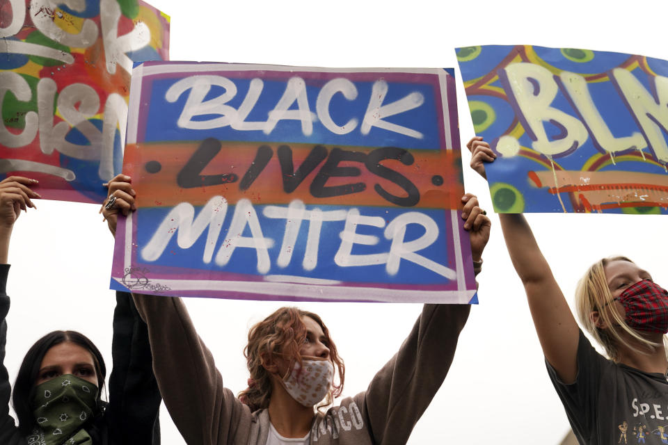 Protesters chant, Wednesday, Sept. 23, 2020, in Louisville, Ky. A grand jury has indicted one officer on criminal charges six months after Breonna Taylor was fatally shot by police in Kentucky. The jury presented its decision against fired officer Brett Hankison Wednesday to a judge in Louisville, where the shooting took place. (AP Photo/John Minchillo)