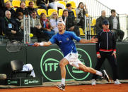 Italy's Andreas Seppi returns the ball to Britain's Andy Murray during their Davis Cup World Group quarterfinal match in Naples, Italy, Friday, April 4, 2014. (AP Photo/Salvatore Laporta)
