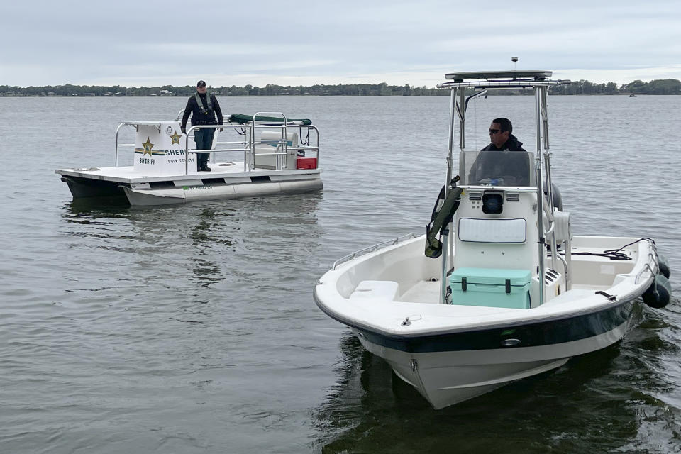 This photo released by the Polk County Sheriff's Office shows authorities searching for two missing boaters in Lake Eloise, on Sunday, March 19, 2023, in Winter Haven, Fla. (Polk County Sheriff's Office via AP)