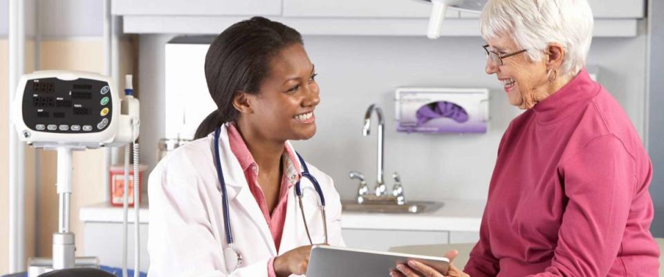 Doctor Discussing Records With Senior Female Patient