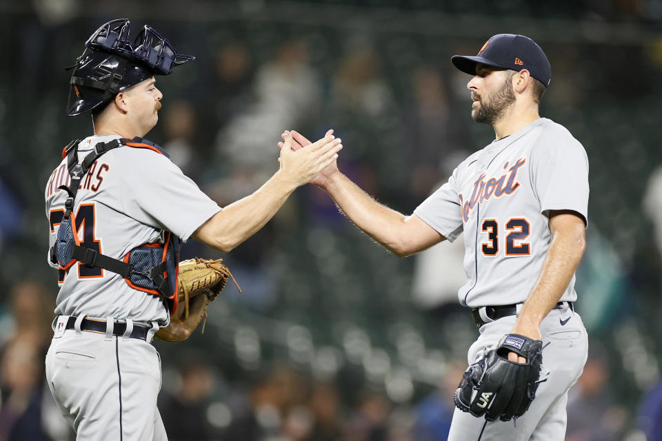 SEATTLE, WASHINGTON - MAY 17: Jake Rogers #34 and Michael Fulmer #32 of the Detroit Tigers high five after defeating the Seattle Mariners 4-1 at T-Mobile Park on May 17, 2021 in Seattle, Washington. (Photo by Steph Chambers/Getty Images)