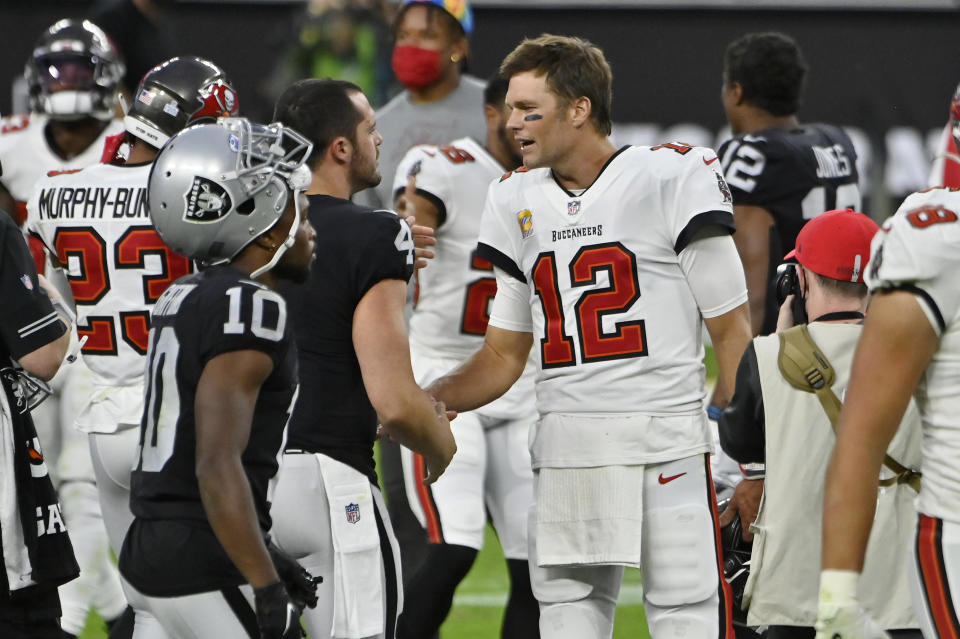 Tampa Bay Buccaneers quarterback Tom Brady (12) greets Las Vegas Raiders quarterback Derek Carr (4) after an NFL football game, Sunday, Oct. 25, 2020, in Las Vegas. (AP Photo/David Becker)