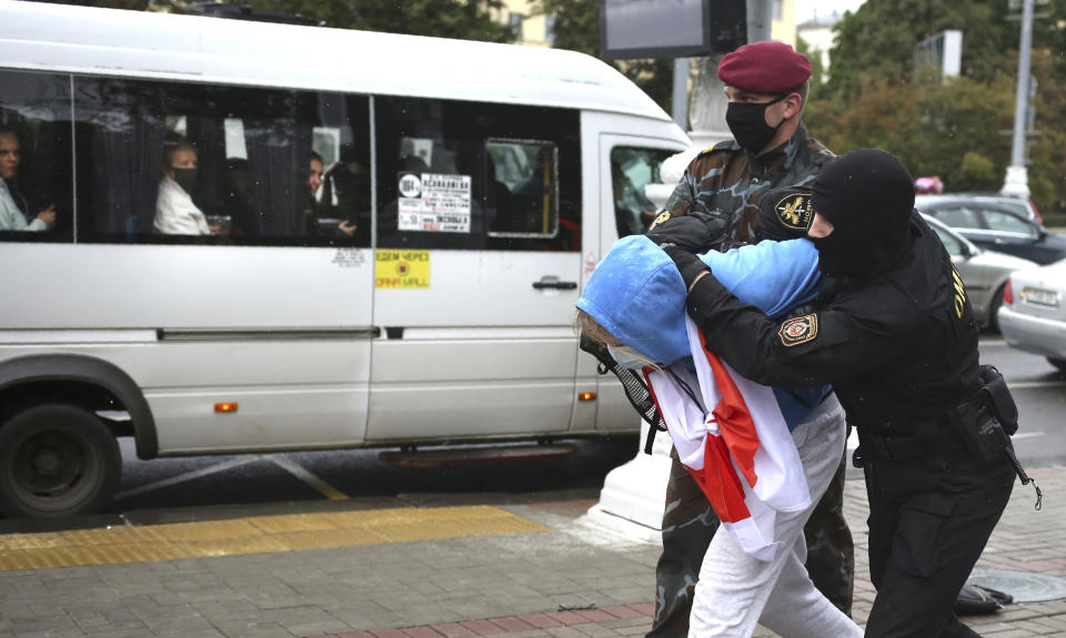 Police detain a student during a protest in Minsk, Belarus, Tuesday, Sept. 1, 2020. Several hundred students on Tuesday gathered in Minsk and marched through the city center, demanding the resignation of the country's authoritarian leader after an election the opposition denounced as rigged. Many have been detained as police moved to break up the crowds. (Tut.By via AP)