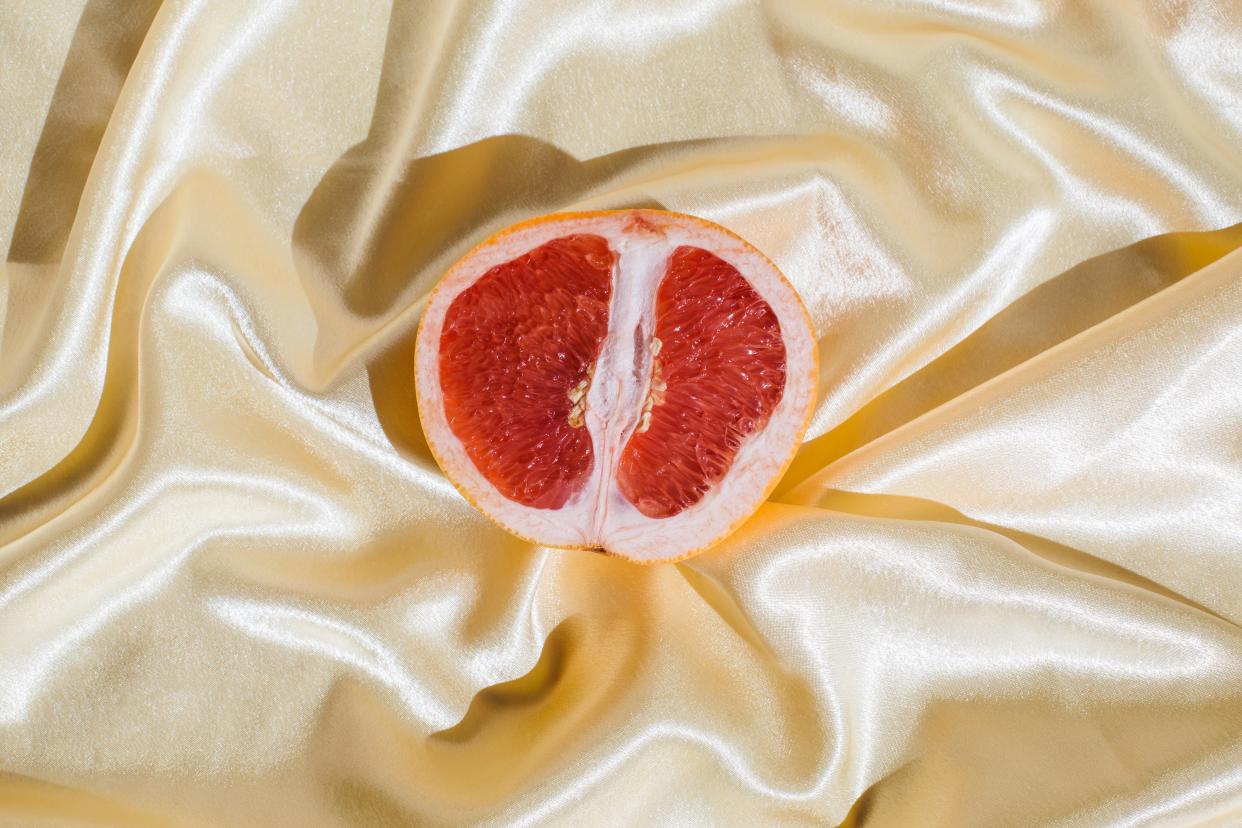 Grapefruit on gold silk sheet