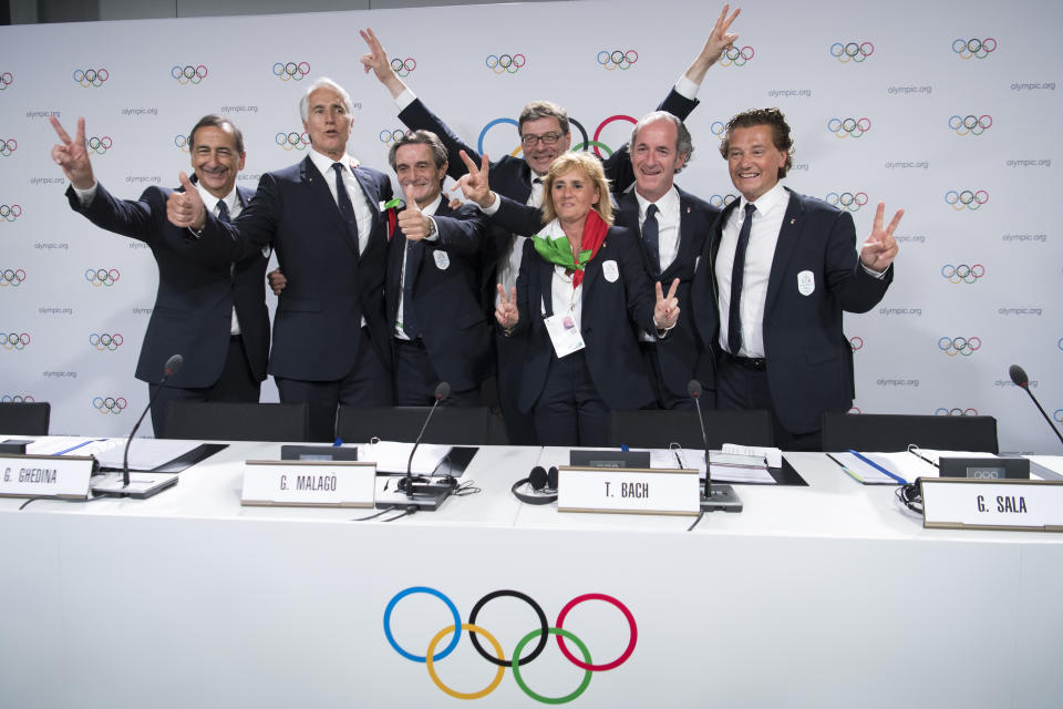 From left, the Mayor of Milan Giuseppe Sala, Italy's National Olympic Committee (CONI) president Giovanni Malago, Italy's Lombardy region President Attilio Fontana, Italy's Under Secretary of State Giancarlo Giorgetti, Italy's Olympic Gold Medallist in Fencing Diana Bianchedi, Italy's Veneto Region President Luca Zaia and Mayor of Cortina Gianpietro Ghedina pose after Milan-Cortina won the bid to host the 2026 Winter Olympic Games, during the first day of the 134th Session of the International Olympic Committee (IOC), at the SwissTech Convention Centre, in Lausanne, Switzerland, Monday, June 24, 2019. Italy will host the 2026 Olympics in Milan and Cortina d'Ampezzo, taking the Winter Games to the Alpine country for the second time in 20 years. (Laurent Gillieron/Keystone via AP)