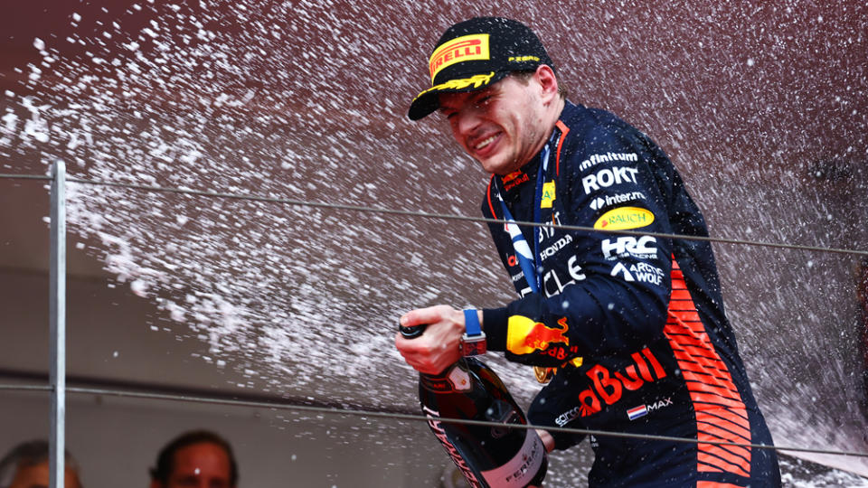 Max Verstappen celebrates on the podium after winning the 2023 Monaco Grand Prix.