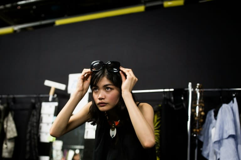 Japanese model Rina Fukushi prepares back stage for the Tae Ashida 2017 Spring/Summer collection show by designer Tae Ashida in Tokyo