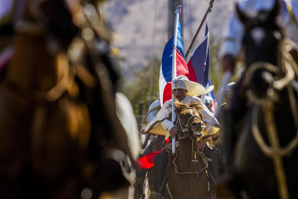 Chilean horseback riders known as "Huasos", take part in the Quasimodo Feast, a celebration held on the first Sunday after Easter, in Colina, Chile, April 7, 2024. The "Huasos" accompany priests to give communion to the sick, in a procession to pay tribute to the Virgin of Carmen. (AP Photo/Esteban Felix)