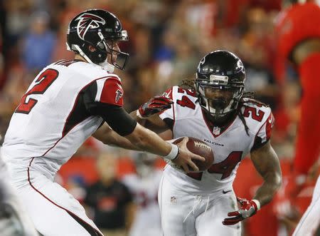 Nov 3, 2016; Tampa, FL, USA; Atlanta Falcons running back Devonta Freeman (24) takes a handoff from quarterback Matt Ryan (2) during the second quarter of a football game against the Tampa Bay Buccaneers at Raymond James Stadium. Mandatory Credit: Reinhold Matay-USA TODAY Sports