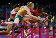 LONDON, ENGLAND - AUGUST 07: Sally Pearson of Australia leads Nevin Yanit of Turkey and Kellie Wells of the United States during the Women's 100m Hurdles Final on Day 11 of the London 2012 Olympic Games at Olympic Stadium on August 7, 2012 in London, England. (Photo by Jamie Squire/Getty Images)