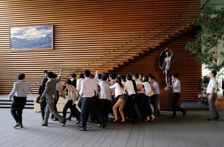 Japan's Defense Minister Tomomi Inada is surrounded by reporters as she leaves Prime Minister Shinzo Abe's official residence in Tokyo, Japan July 28, 2017. REUTERS/Toru Hanai