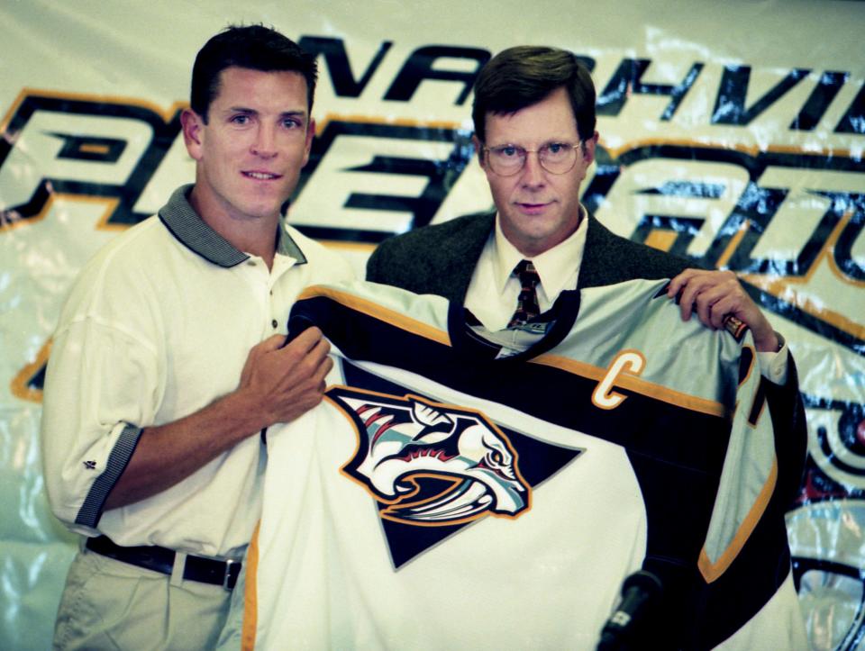 New Nashville Predators signee Tom Fitzgerald, left, and General Manager David Poile holds the captain jersey after the team made Fitzgerald its very first captain during a press conference at the Nashville Arena on July 6, 1998. D. Patrick Harding / For The Tennessean