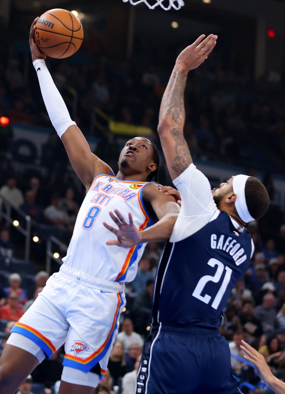 Jalen Williams (8) goes up for a basket as Dallas Mavericks' Daniel Gafford (21) defends in the first half of the NBA basketball game between the Oklahoma City Thunder and Dallas Mavericks at Paycom Center in Oklahoma City, Thursday, March 14, 2024.