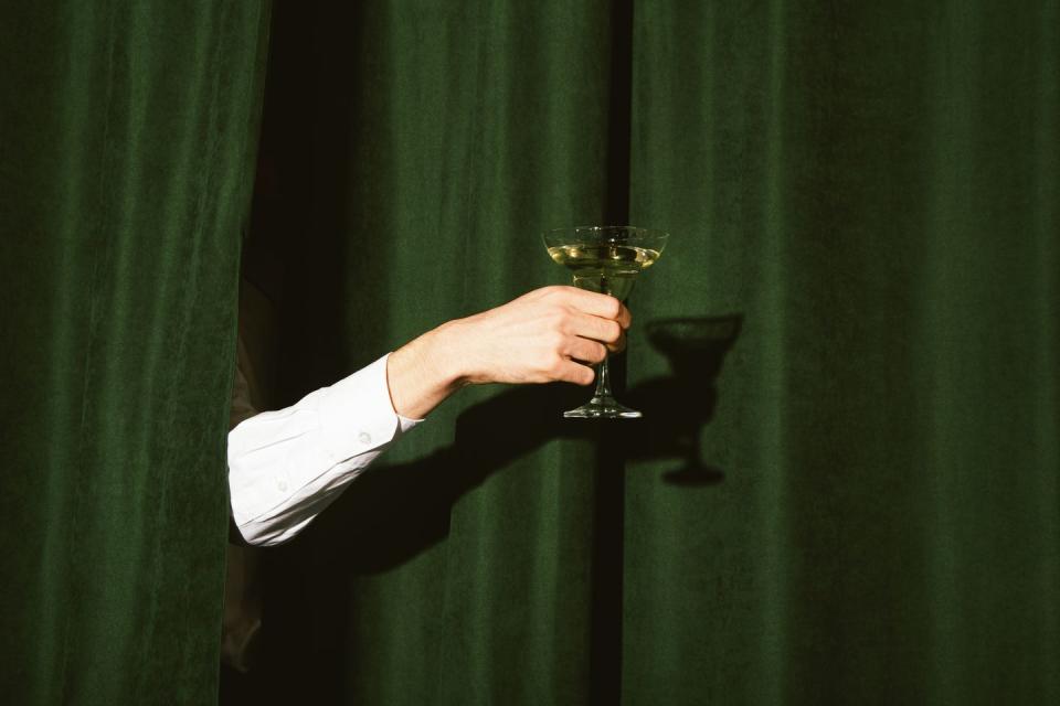 hand with a martini glass