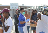 In this photo taken Thursday, April 2, 2020 medical workers prepare to test people for COVID-19 at a testing clinic in Khayelitsha, Cape Town, South Africa. South Africa, one of the world's most unequal countries with a large population vulnerable to the new coronavirus, may have an advantage in the coronavirus outbreak, honed during years battling HIV and tuberculosis: the know-how and infrastructure to conduct mass testing. (AP Photo/Nardus Engelbrecht)