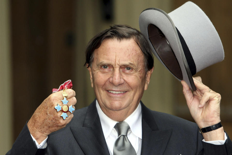 FILE - Australian entertainer Barry Humphries poses for pictures after he received his Most Excellent Order of the British Empire from Britain's Queen Elizabeth II at Buckingham Palace, London, on Oct. 10, 2007. Tony Award-winning comedian Barry Humphries, internationally renowned for his garish stage persona Dame Edna Everage, a condescending and imperfectly-veiled snob whose evolving character has delighted audiences over seven decades, died on Saturday, April 22, 2023, after spending several days in a Sydney hospital with complications following hip surgery, a Sydney hospital said. He was 89 years old. (Steve Parsons/Pool Photo via AP, File)