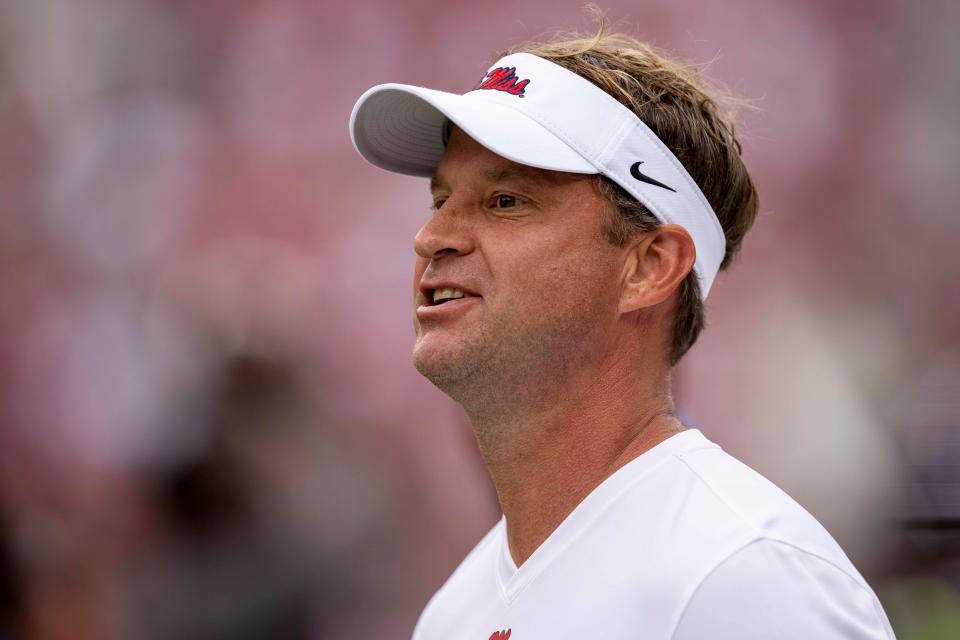 Mississippi head coach Lane Kiffin talks with his players before an NCAA college football game against Alabama, Saturday, Oct. 2, 2021, in Tuscaloosa, Ala. (AP Photo/Vasha Hunt)