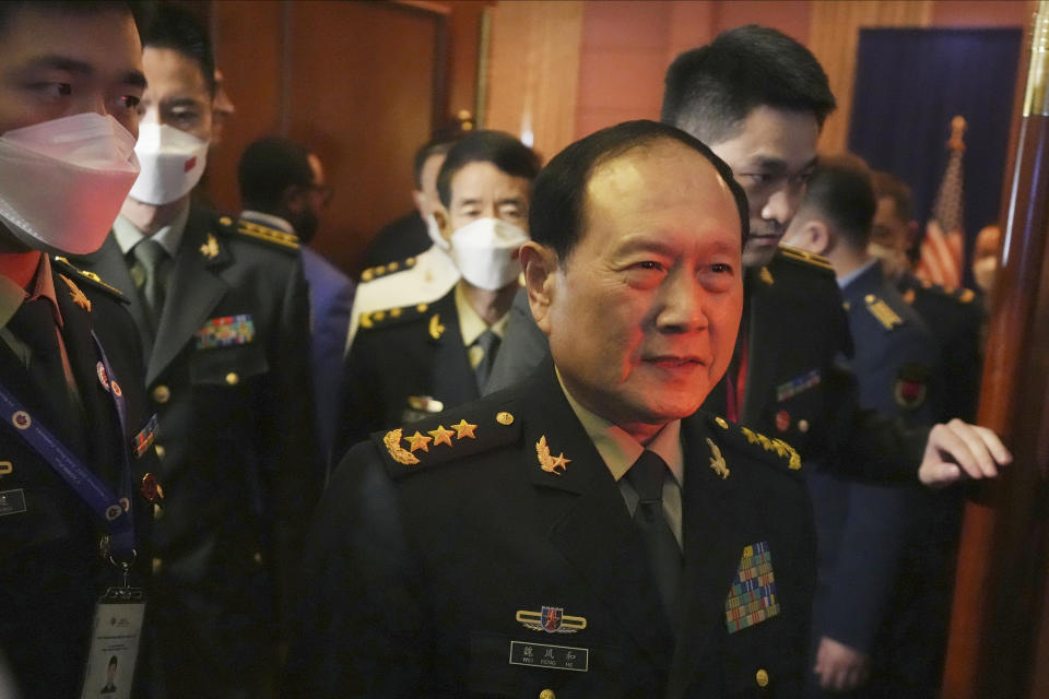 Chinese Defense Minister Gen. Wei Fenghe, front, walks out after a meeting with U.S. Secretary of Defense Lloyd J. Austin III at the venue of the Association of Southeast Asian Nations (ASEAN) Defense Ministers' Meeting (ADMM) in Siem Reap, Cambodia, Tuesday, Nov. 22, 2022. (AP Photo/Heng Sinith)