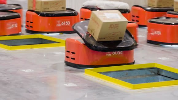 A robot sorts a cardboard package  at JD's fully automated warehouse.