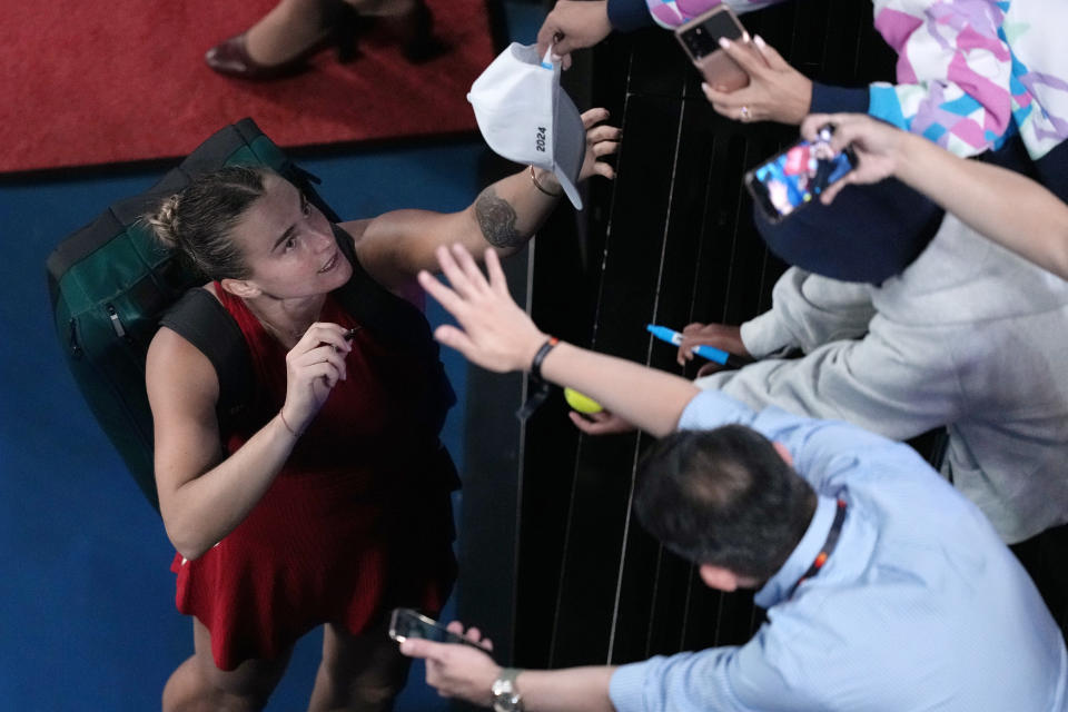 Aryna Sabalenka of Belarus signs autographs after defeating Coco Gauff of the U.S. in their semifinal match at the Australian Open tennis championships at Melbourne Park, Melbourne, Australia, Thursday, Jan. 25, 2024.(AP Photo/Louise Delmotte)