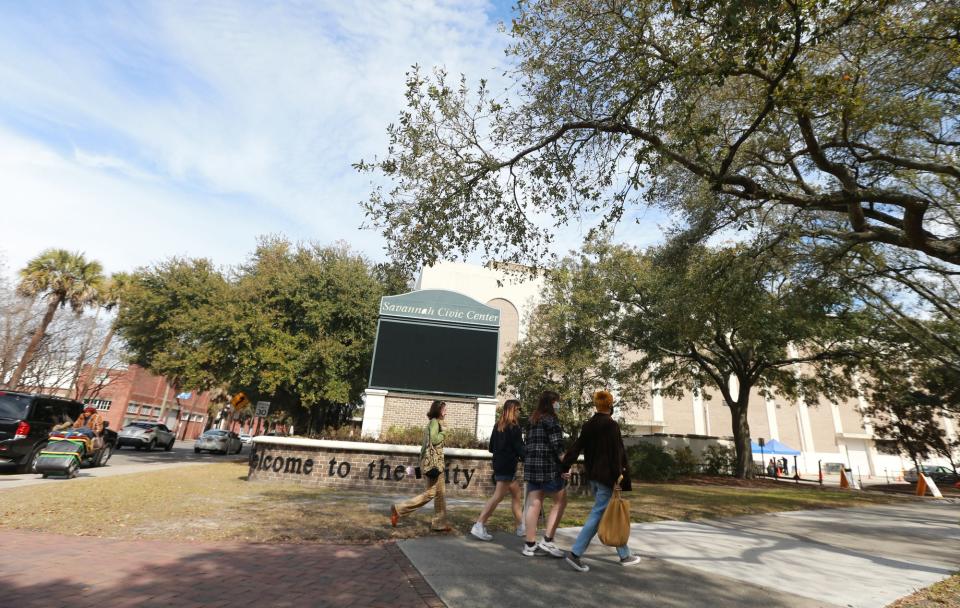 The marquee sign is blank as a group walks along Liberty Street past the Savannah Civic Center.