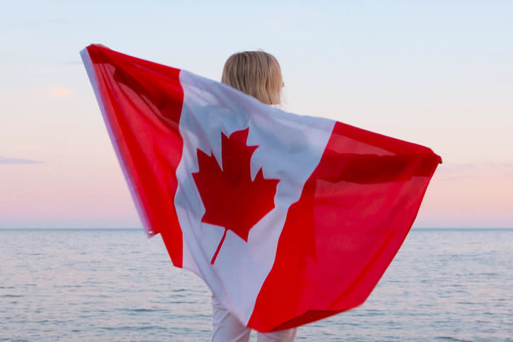 Woman with Canadian flag on beach