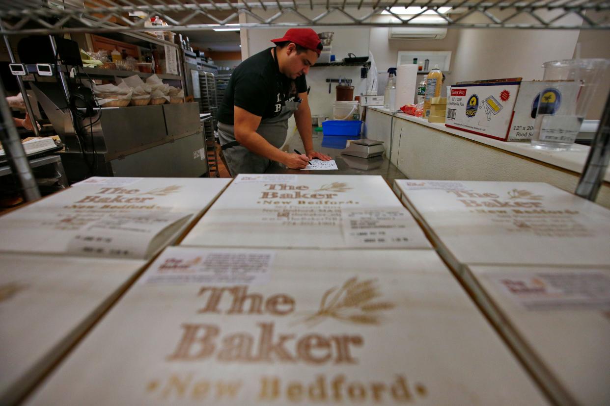 Brandon Roderick, owner, reviews the list of fifty orders for the popular Friday chicken pot pie which sells out in minutes when availability goes live online at The Baker in downtown New Bedford.