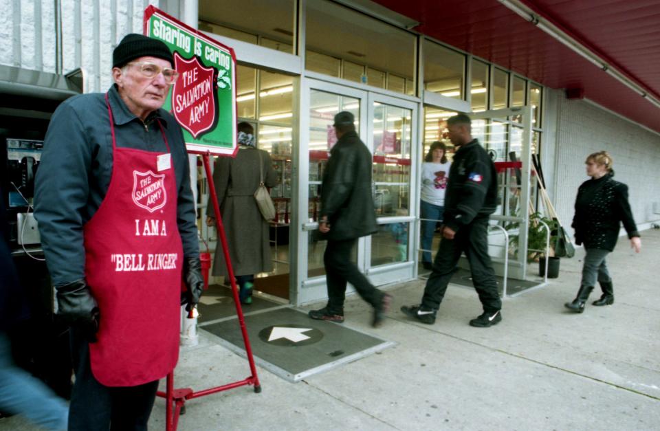 Salvation Army volunteer bell ringer Russell Hogeland, left, waits for contributes for his kettle in front of the Kmart on Charlotte Pike on Dec. 17, 1993. Salvation Army officials say contributions funds are down more than $120,000 from last year.