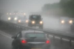 Motorists drive in heavy rain