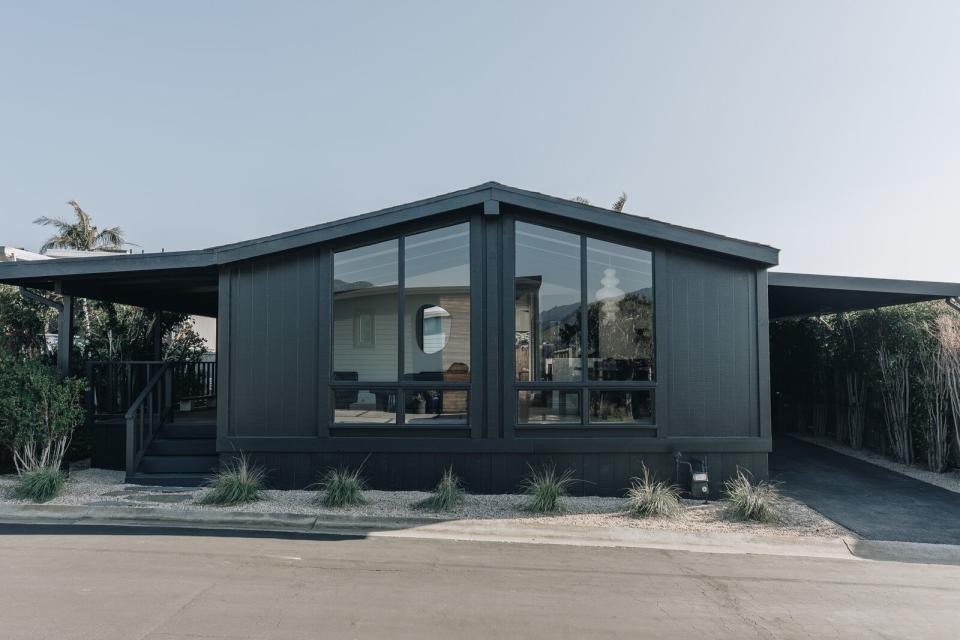 The couple updated the exterior with Benjamin Moore's Green Black. "It's easier and more complicated to renovate a mobile home,