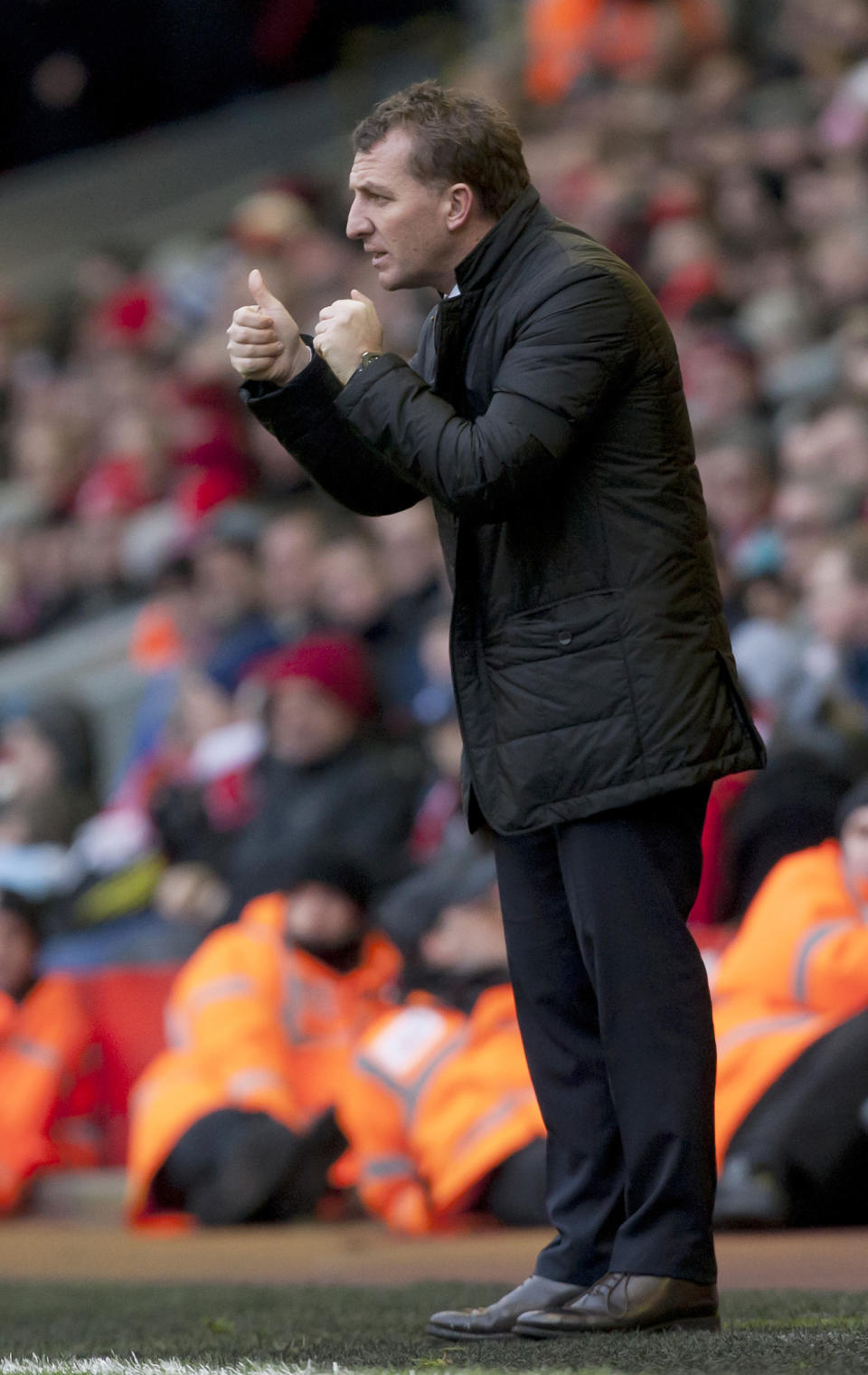 Liverpool's manager Brendan Rodgers gives a thumbs-up signal to his players as he watches his team's English Premier League soccer match against Arsenal at Anfield Stadium, Liverpool, England, Saturday Feb. 8, 2014. (AP Photo/Jon Super)