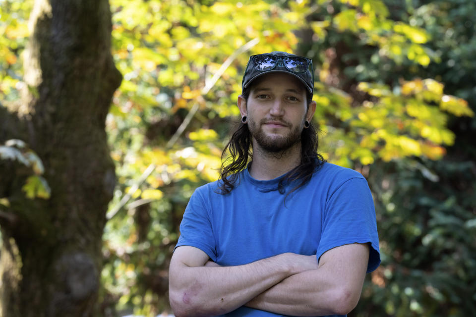 Washington Park Arboretum arborist Shea Cope is pictured, on Friday, Oct. 7, 2022, in Seattle. Cities across the world have promised to plant more carbon-absorbing trees to help fight climate change. “We’re losing conifers faster than our broad leaf, deciduous ones,” Cope added as he surveyed a towering knobcone pine with half its canopy dead. (AP Photo/Stephen Brashear)