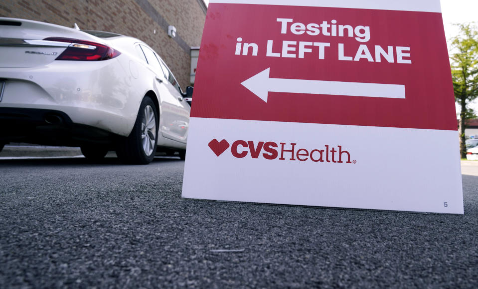 Cars wait in line at a CVS pharmacy offering drive-thru COVID-19 nasal swab tests in Dallas, Friday, Sept. 18, 2020. (AP Photo/LM Otero)