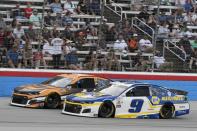 Kurt Busch, left, and Chase Elliott (9) head down the front stretch during the NASCAR Cup Series All-Star auto race at Texas Motor Speedway in Fort Worth, Texas, Sunday, June 13, 2021. (AP Photo/Larry Papke)