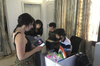 A stranded foreign tourist checks her mobile as she stands at the reception desk of a hostel in New Delhi, India, Thursday, April 2, 2020. Dozens of tourists from Britain, Canada and Australia are finding themselves stranded in the Indian capital with their vacations abruptly ended by India’s three-week lockdown and stopping of international flights amid new coronavirus. (AP Photo/Shonal Ganguly)