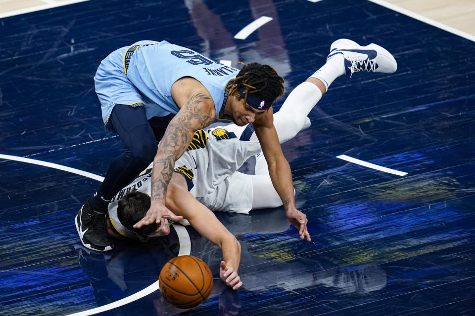 Memphis Grizzlies forward Brandon Clarke (15) and Indiana Pacers forward Doug McDermott (20) go for a loose ball during the second half of an NBA basketball game in Indianapolis, Tuesday, Feb. 2, 2021. (AP Photo/Michael Conroy)