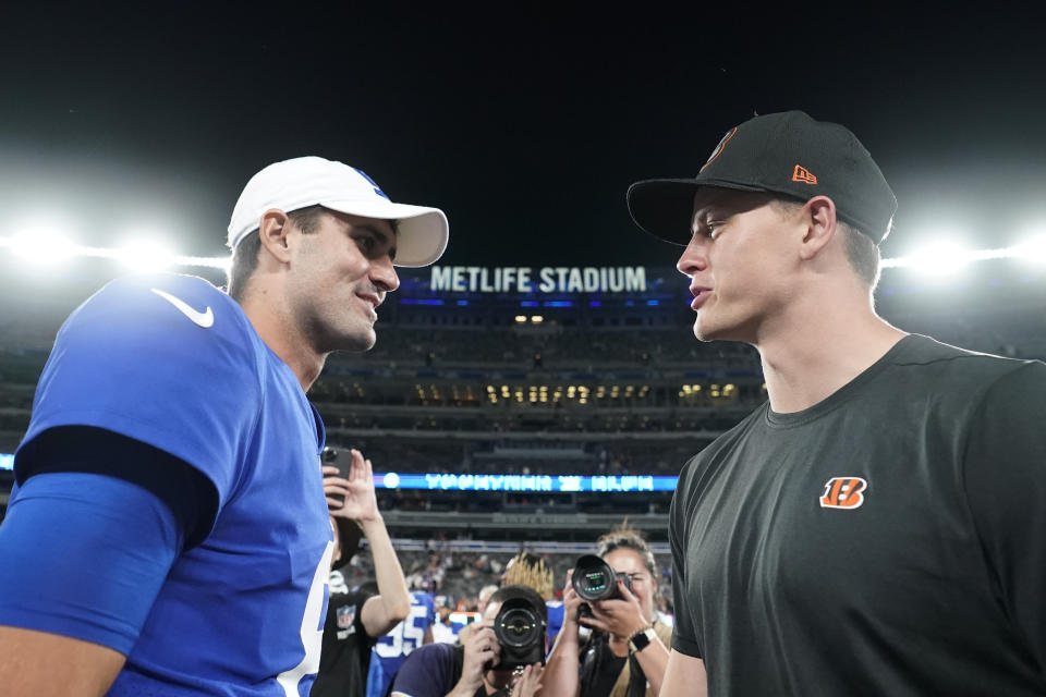 New York Giants quarterback Daniel Jones, left, talks with Cincinnati Bengals quarterback Joe Burrow after a preseason NFL football game Sunday, Aug. 21, 2022, in East Rutherford, N.J. The Giants won 25-22. (AP Photo/John Minchillo)