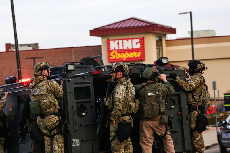 Law enforcement officers in tactical gear are seen at the site of a shooting at a King Soopers grocery store in Boulder