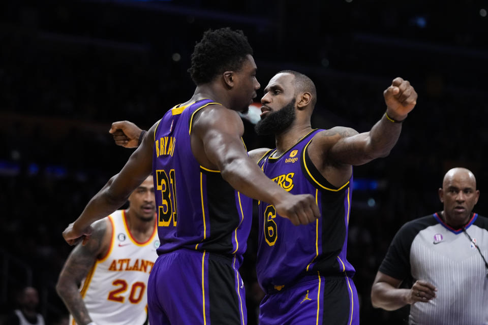 Los Angeles Lakers' Thomas Bryant (31) and LeBron James (6) celebrate after Bryant scored a basket and drew a foul during the first half of the team's NBA basketball game against the Atlanta Hawks on Friday, Jan. 6, 2023, in Los Angeles. (AP Photo/Jae C. Hong)