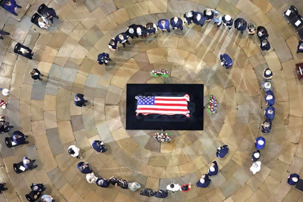 PHOTO:  Family members stand in a circle around Herschel  'Woody ' Williams' flag-draped casket laying in honor in the US Capitol Rotunda on July 14, 2022 in Washington, DC.  (Pool/Getty Images)