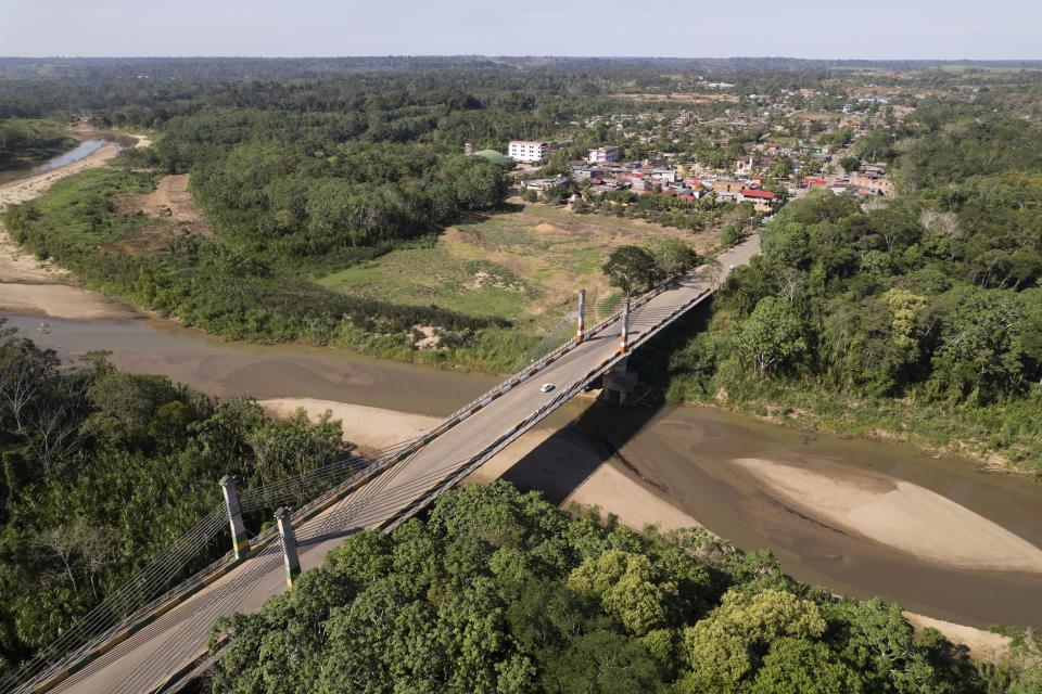 The Integration border bridge connects Assis, Brazil, left, and Iñapari, Peru, Thursday, June 20, 2024. Migrants, police, officials and analysts say President Joe Biden’s halt on asylum have caused a wait-and-see attitude among migrants staying in Brazil, placing their plans of reaching the U.S. on hold. (AP Photo/Martin Mejia)