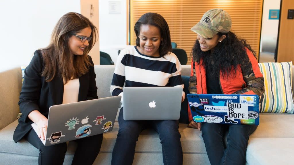 women sitting with laptops