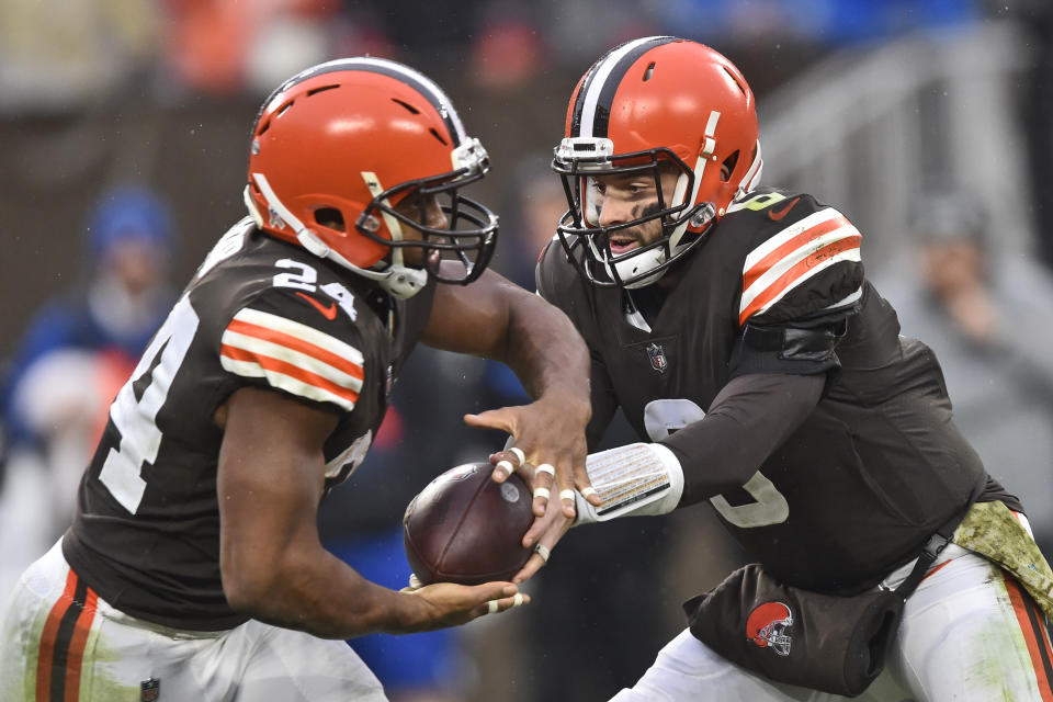 Cleveland Browns quarterback Baker Mayfield (6) hands off the ball to running back Nick Chubb (24) during the second half of an NFL football game against the Detroit Lions, Sunday, Nov. 21, 2021, in Cleveland. (AP Photo/David Richard)