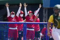 Japanese players celebrate a run score by Minori Naito during the softball game between Japan and Australia at the 2020 Summer Olympics, Wednesday, July 21, 2021, in Fukushima, Japan. (AP Photo/Jae C. Hong)