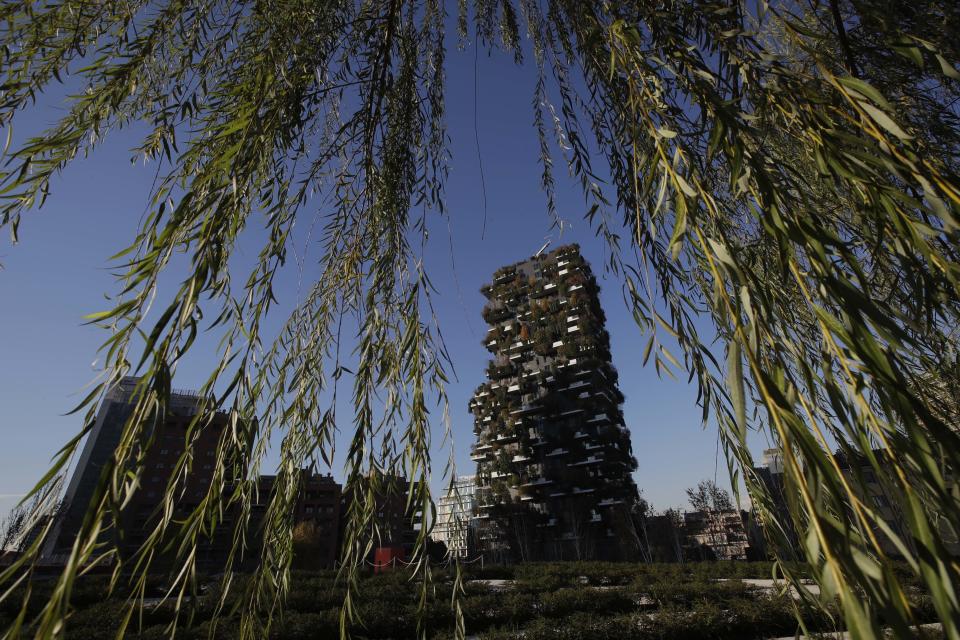 In this picture taken on Tuesday, Nov. 27, 2018, a view of the vertical forest residential towers in Milan, Italy. If Italy's fashion capital has a predominant color, it is gray not only because of the blocks of uninterrupted neoclassical stone buildings for which the city is celebrated, but also due to the often-gray sky that traps in pollution. The city has ambitious plans to plant 3 million new trees by 2030_ a move that experts say could offer relief to the city’s muggy and sometimes tropical weather. (AP Photo/Luca Bruno)