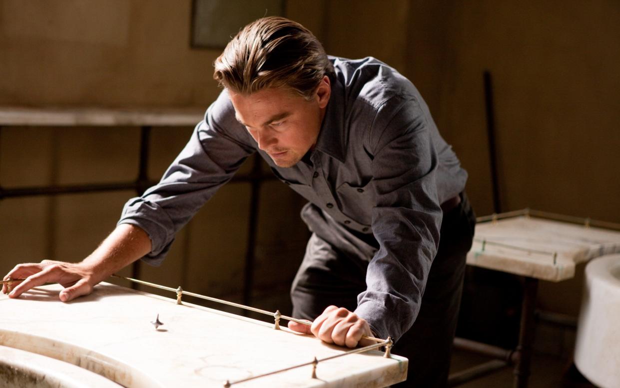 Is Cobb (Leonardo DiCaprio) in the real world, his subconscious, or someone else's? - Warner Bros