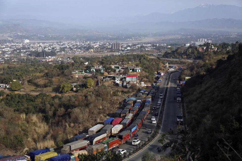 Trucks stand stranded on the main highway connecting Jammu and Srinagar, on the outskirts of Jammu, India, Saturday, Jan.28,2017. Heavy snowfall has cut off roads and disrupted power and communications in Kashmir, and hundreds of residents have been evacuated from high-risk areas. (AP Photo/Channi Anand )