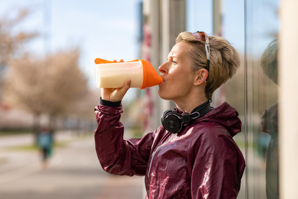 Someone drinking a protein shake